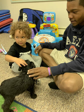 Dad & child playing with puppy during visitation