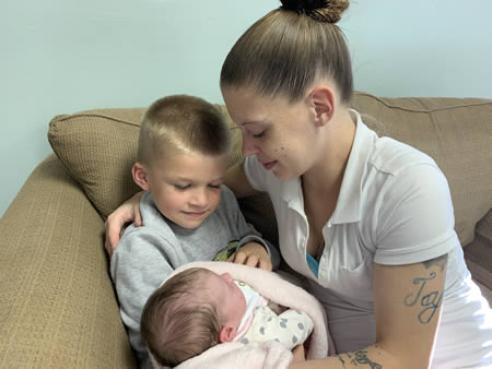 Mom and big brother loving the new baby